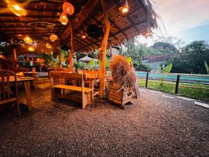a restaurant with a table and chairs and a fence at The Elephant Next-Door in Udawalawe