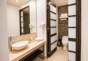 a bathroom with a sink and a toilet at San Simon Hotel Pereira By Soratama in Pereira +5 photos