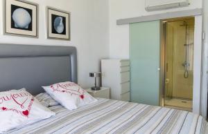 a bedroom with a bed with two pillows on it at Meloneras in Meloneras +25 photos