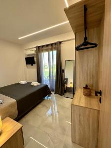 a bedroom with a black bed and a mirror at Fanari Meltemi Apartment in Fanari
