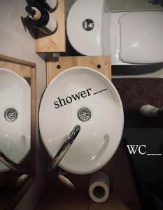 a bathroom sink with the word shower written on it at Airport Moonlight Tallinn in Tallinn