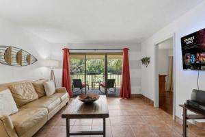 a living room with a couch and a table at 14th Hole Golf Course Views! in Wesley Chapel