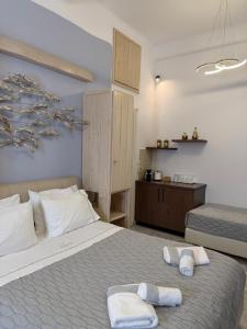 a bedroom with a bed with towels on it at Starlight Luxury Studios in Mikonos