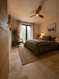a bedroom with a bed and a ceiling fan at Domaine Saveria in Ponte-Leccia