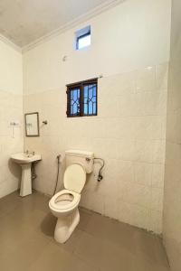 a bathroom with a toilet and a sink at 3 BHK solana in Jaipur +5 photos