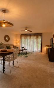 a living room with a table and a couch at Domaine Saveria in Ponte-Leccia +8 photos