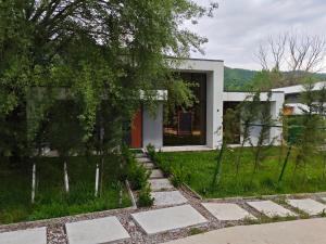 a white house with a walkway in front of it at Harmony Hideaway 2 in Gabala
