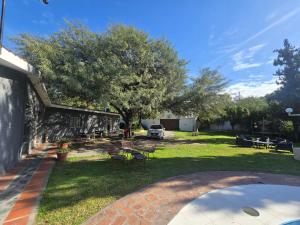 a yard with a tree and a car parked at Finca Don Celestino in La Banda