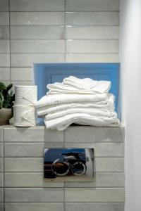 a pile of white towels and a pair of scissors at Casa Amore in Ermoupoli +39 photos