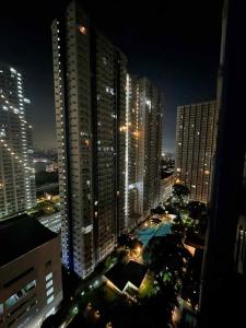 a view of a city at night with tall buildings at JJ Staycation Tower 2 in Manila