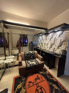 a living room with a couch and a large wall at JJ Staycation Tower 2 in Manila
