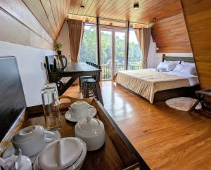 a room with a bed and a table with dishes at Keshiya Holiday Home in Nuwara Eliya