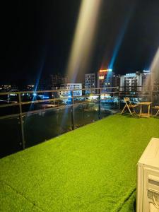 a balcony with a view of a city at night at Seven Star Heights in Rawalpindi