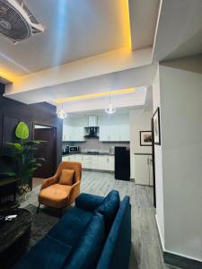 a living room with a blue couch and a chair at Seven Star Heights in Rawalpindi