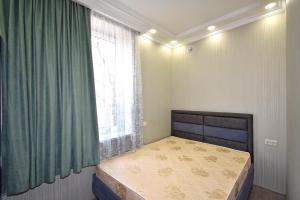 a small bedroom with a bed and a window at Рядом с метро in Yerevan