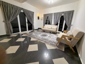 a living room with a checkered floor at AmaniStay Cameron Highlands in Cameron Highlands