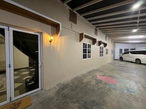 a garage with a white car parked in it at AmaniStay Cameron Highlands in Cameron Highlands