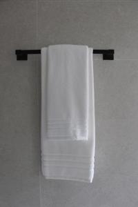 a white towel hanging on a towel rack in a bathroom at Apartamentos Dulce Estrela in Tui +51 photos