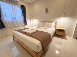 a bedroom with a large bed and a window at Casa Amara in Ko Phangan