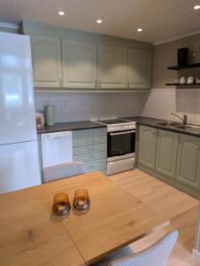 a kitchen with a wooden table with shoes on it at Leilighet på Voss in Vossevangen