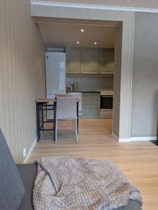 a kitchen with a table and a white refrigerator at Leilighet på Voss in Vossevangen