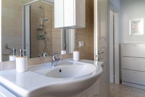 a bathroom with a white sink and a mirror at Cilento Reset in Sapri +23 photos