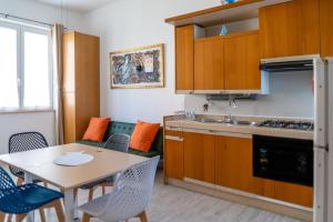 a kitchen with a table and a dining room at Cilento Reset in Sapri