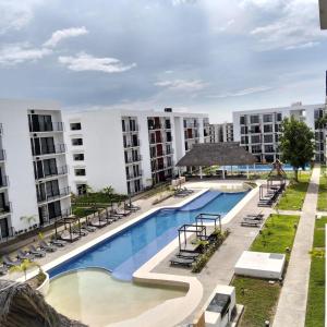 an overhead view of a swimming pool with buildings in the background at Modern apartment with pool , Riviera Nayarit in Naranjo