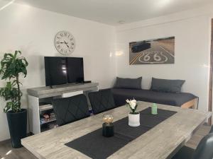 a living room with a table and a couch at Ferienwohnungen Mimi in Kleinengstingen