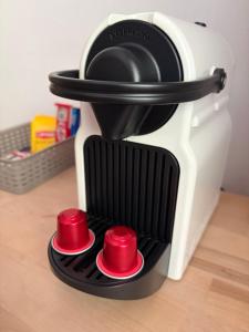 a toaster oven with red cups on top of it at Forest Apartment-Forest Escape Menzenschwand in St. Blasien