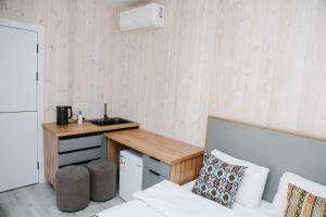 a small kitchen with a counter and a sink in a room at Apple Hostel Bishkek in Bishkek