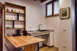 a kitchen with a wooden table and a sink at Romeo Giulietta in Verona +37 photos