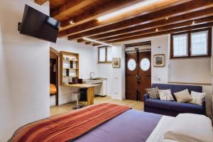 a bedroom with a bed and a couch and a desk at Romeo Giulietta in Verona