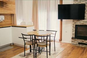 a table and chairs in a kitchen with a fireplace at Sharr Mount in Prizren +161 photos