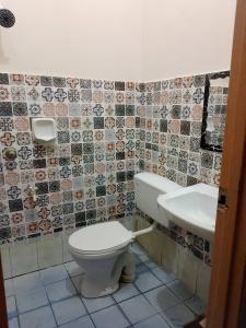 a bathroom with a toilet and a sink at Tipika Room Pasir Pekan in Tumpat