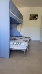 a bed in a room with a bunk bed at Casa Irene in Villasimius