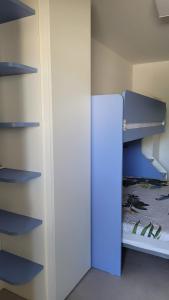 a small room with a bunk bed and a closet at Casa Irene in Villasimius