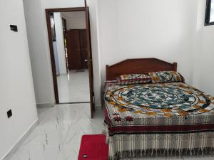 a bedroom with a bed with a quilt on it at Jayasiri Riverfront Home in Lansiyawatta