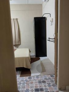 a room with a bedroom with a bed and a door at Tipika Room Pasir Pekan in Tumpat