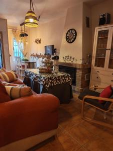 a living room with a couch and a fireplace at Entre Vistas in Zahara de la Sierra