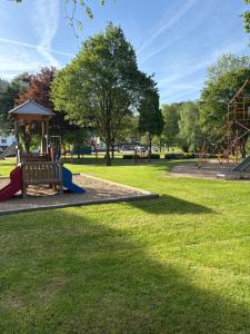a park with a playground and a slide at Am Obersee Hotel in Simmerath