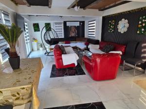 a living room with a red couch and chairs at Vila Darkoni2 in Bijeljina