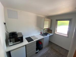 a small kitchen with a counter and a microwave at Carpenters-stay in Dorking +7 photos