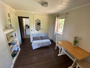 a living room with a couch and a table at Carpenters-stay in Dorking