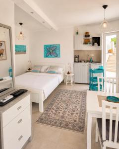 a bedroom with a bed and a table and a kitchen at Gradolina Apartment in Pula
