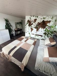 a bedroom with two beds and a map on the wall at Modern apartment with garden in Lostorf