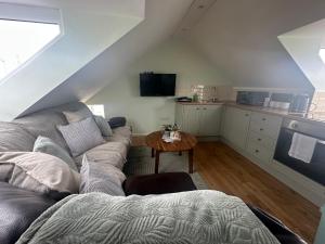 a living room with a couch and a table at Myrtle House Hotel in Tenby