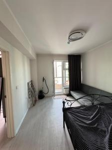 a bedroom with a bed and a window at Cozy Apartment newly furnished in Ulaanbaatar