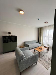 a living room with two couches and a table at Cozy Apartment newly furnished in Ulaanbaatar