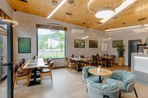 a restaurant with wooden ceilings and tables and chairs at Espadrina Wellness & Spa in Ljubovija